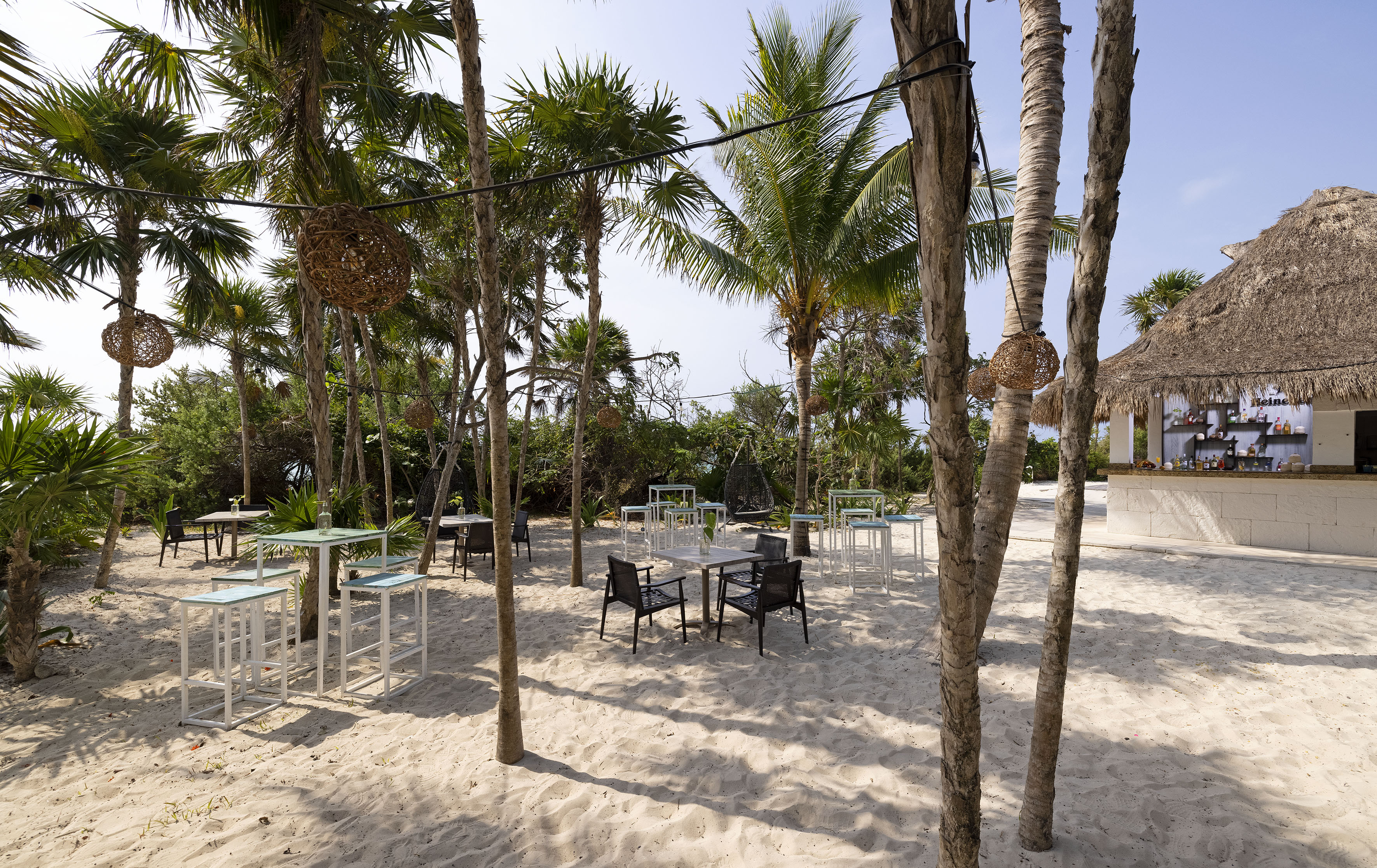 a group of tables and chairs on a beach