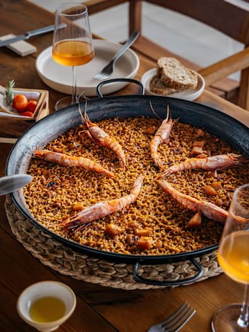 a large pan of food with shrimps on it