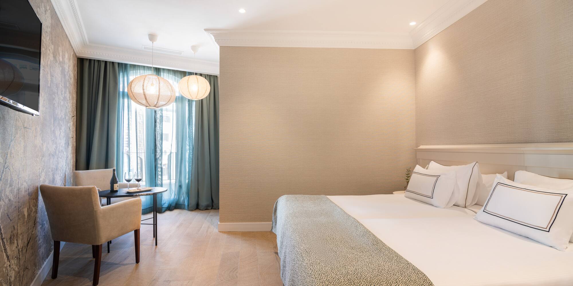 a room with a bed and a table and chairs