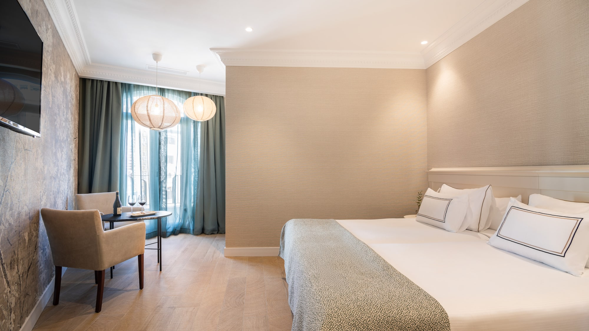 a room with a bed and a table and chairs