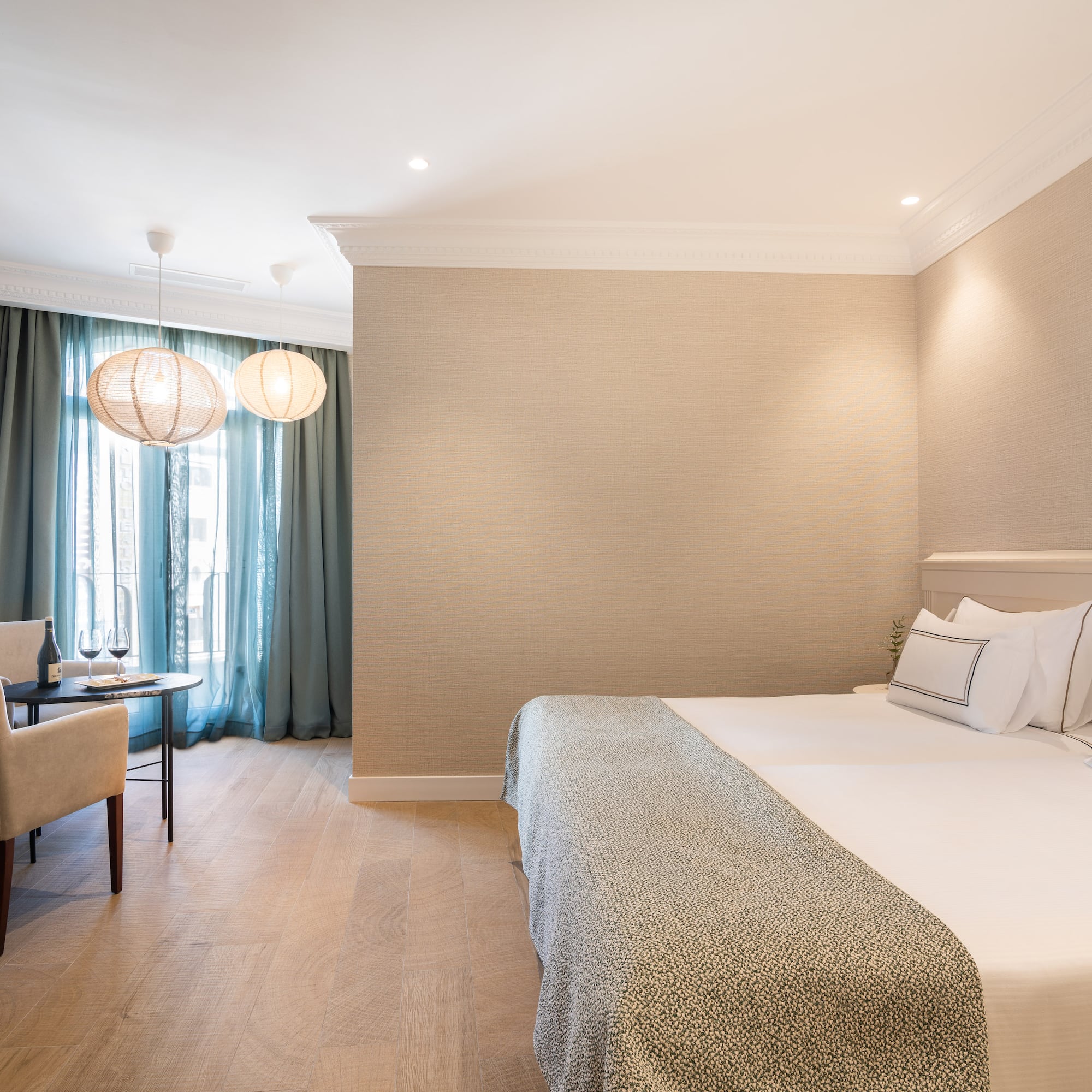 a room with a bed and a table and chairs