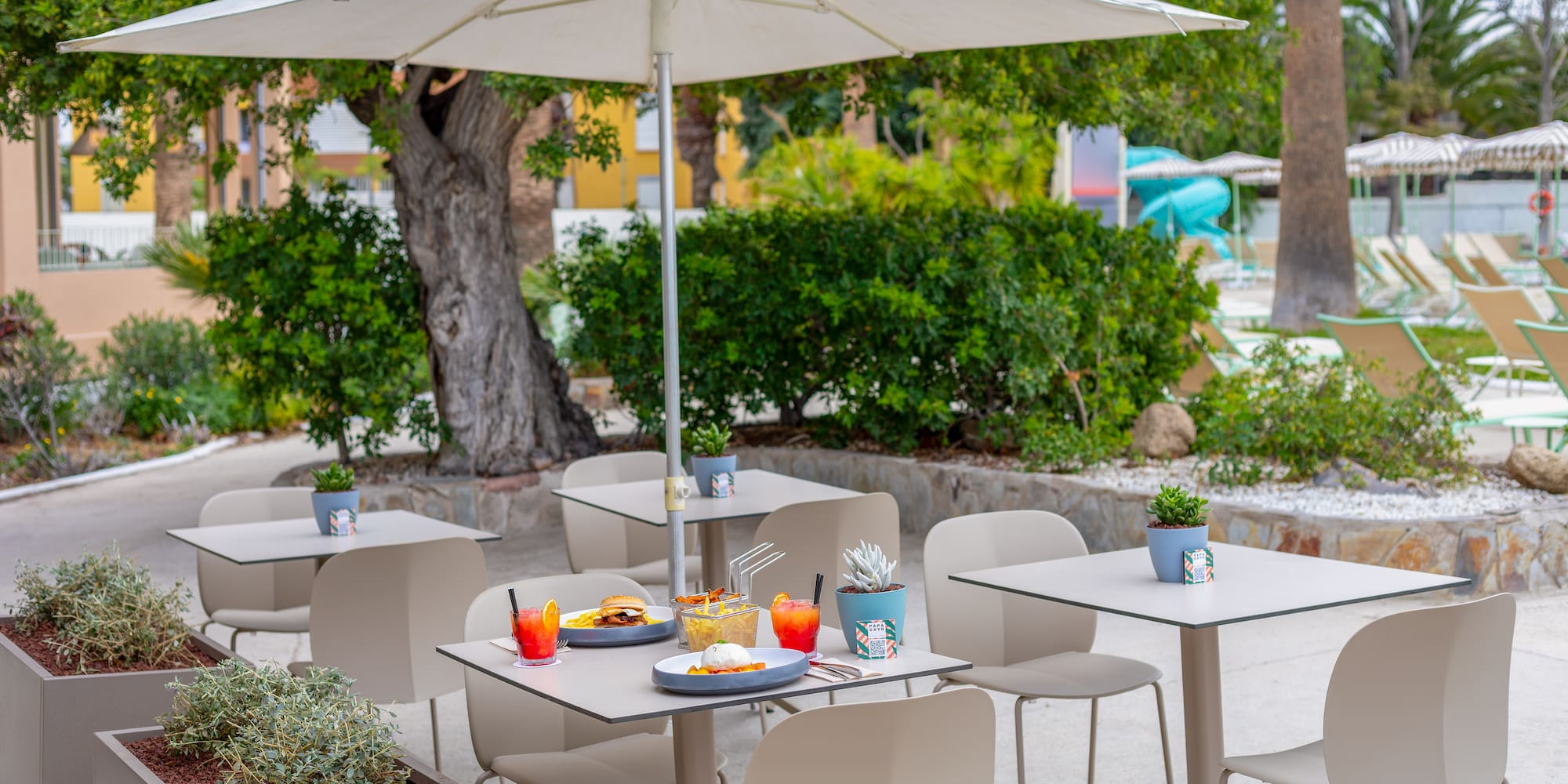 a table and chairs under an umbrella