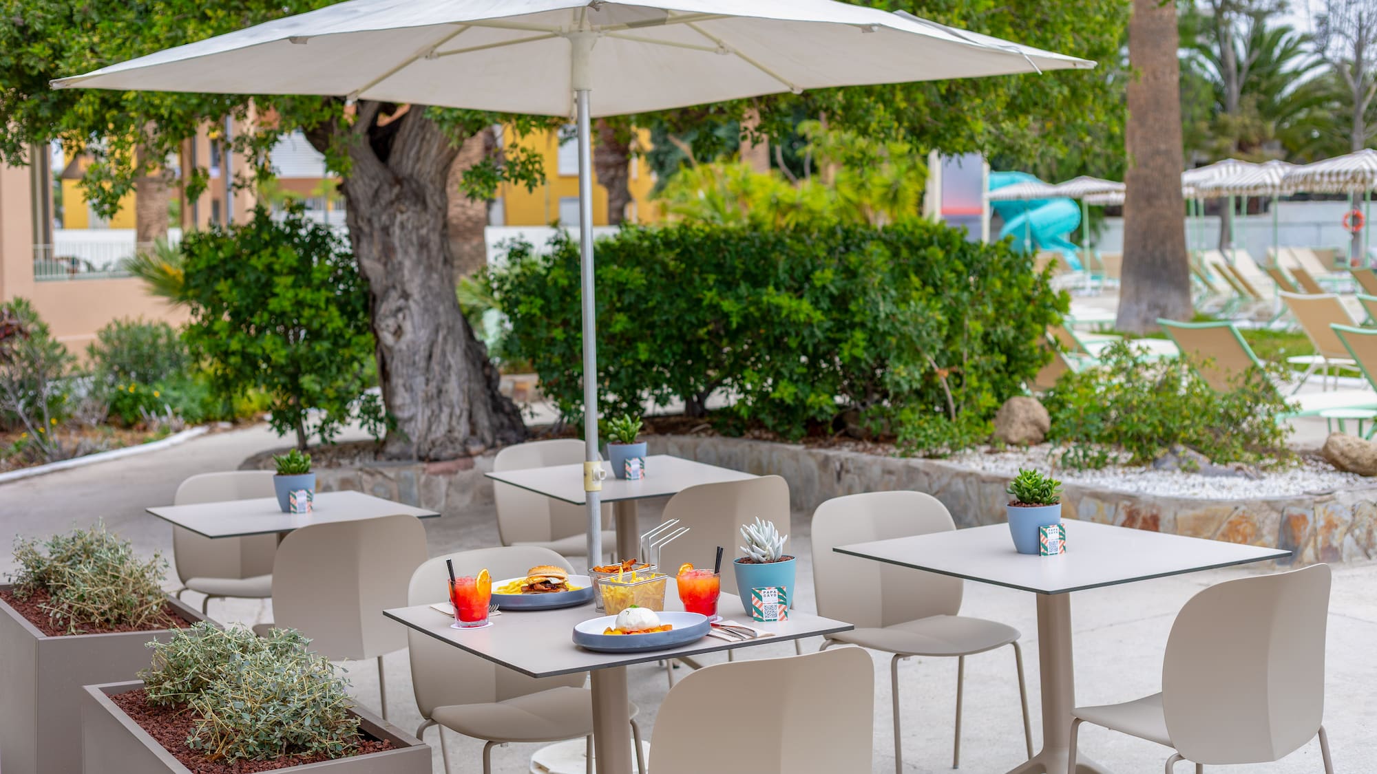 a table and chairs under an umbrella