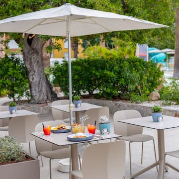 a table and chairs under an umbrella