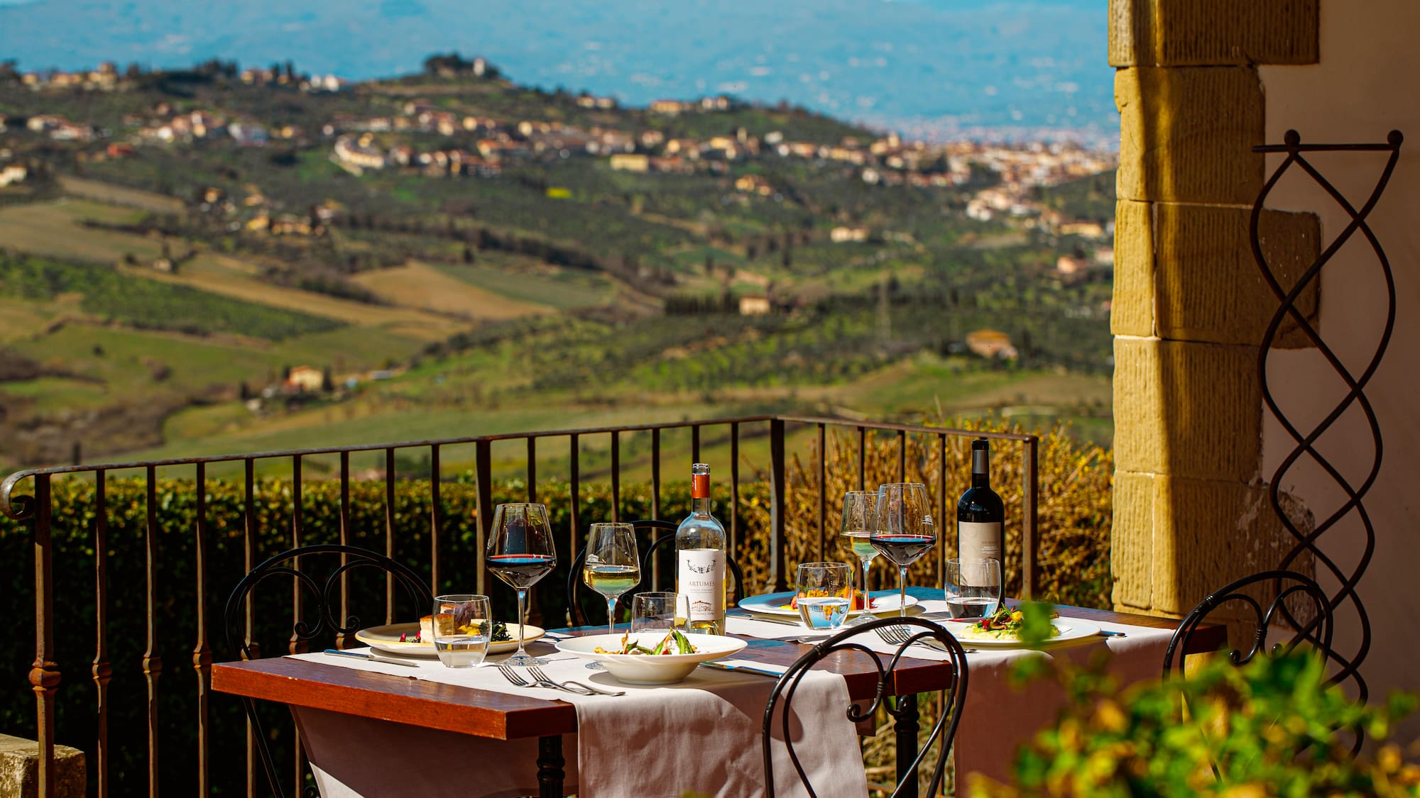 a table with wine glasses and bottles on it