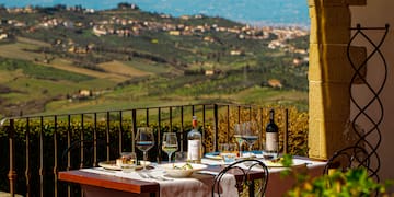 a table with wine glasses and bottles on it