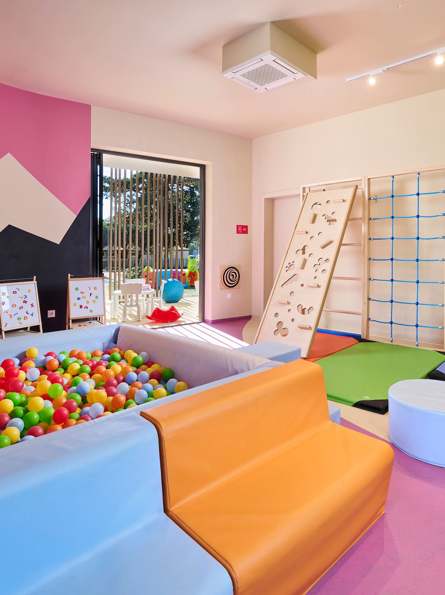 a room with a ball pit and a play area