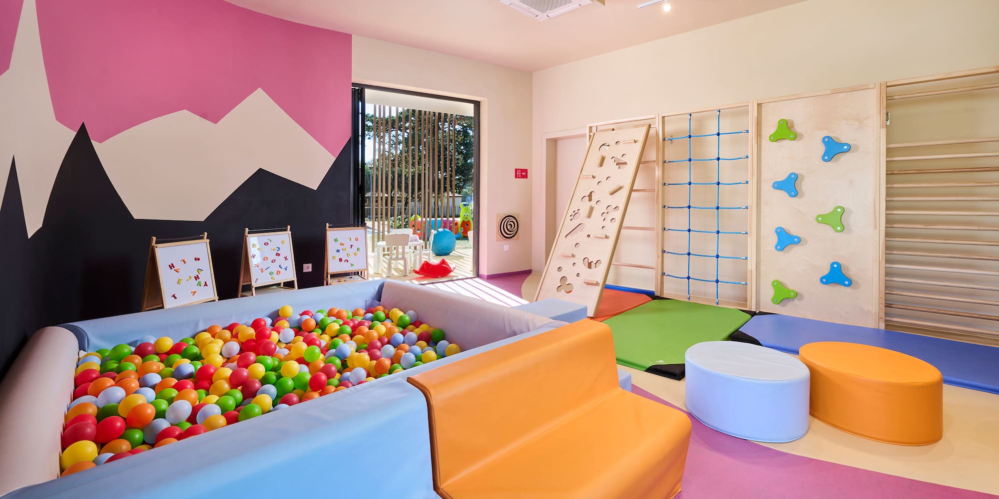 a room with a ball pit and a play area