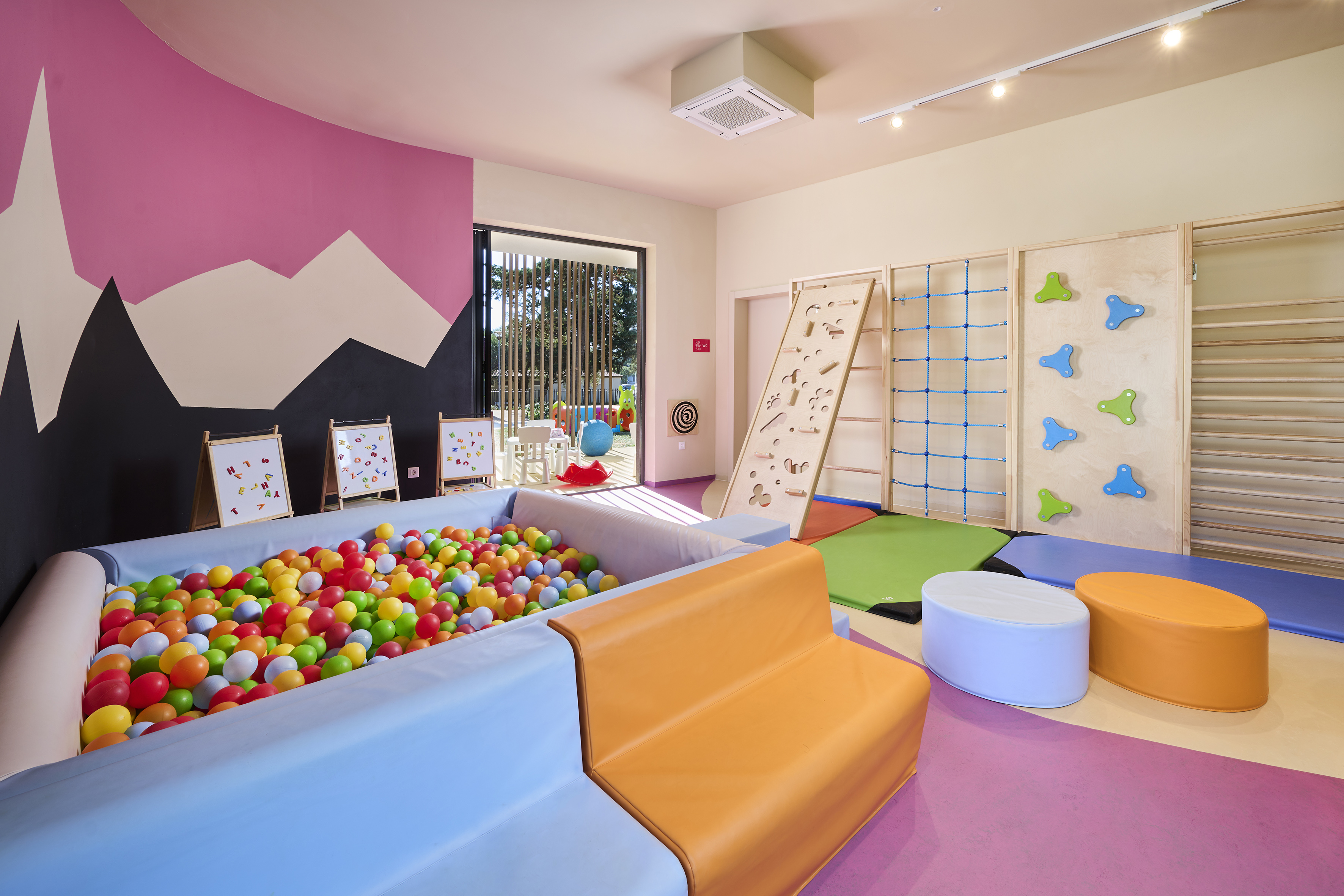 a room with a ball pit and a play area