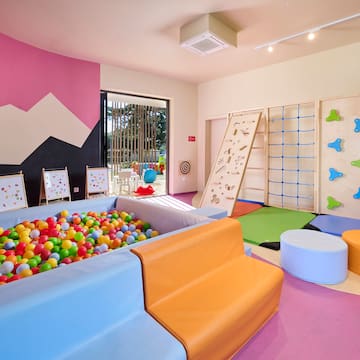 a room with a ball pit and a play area