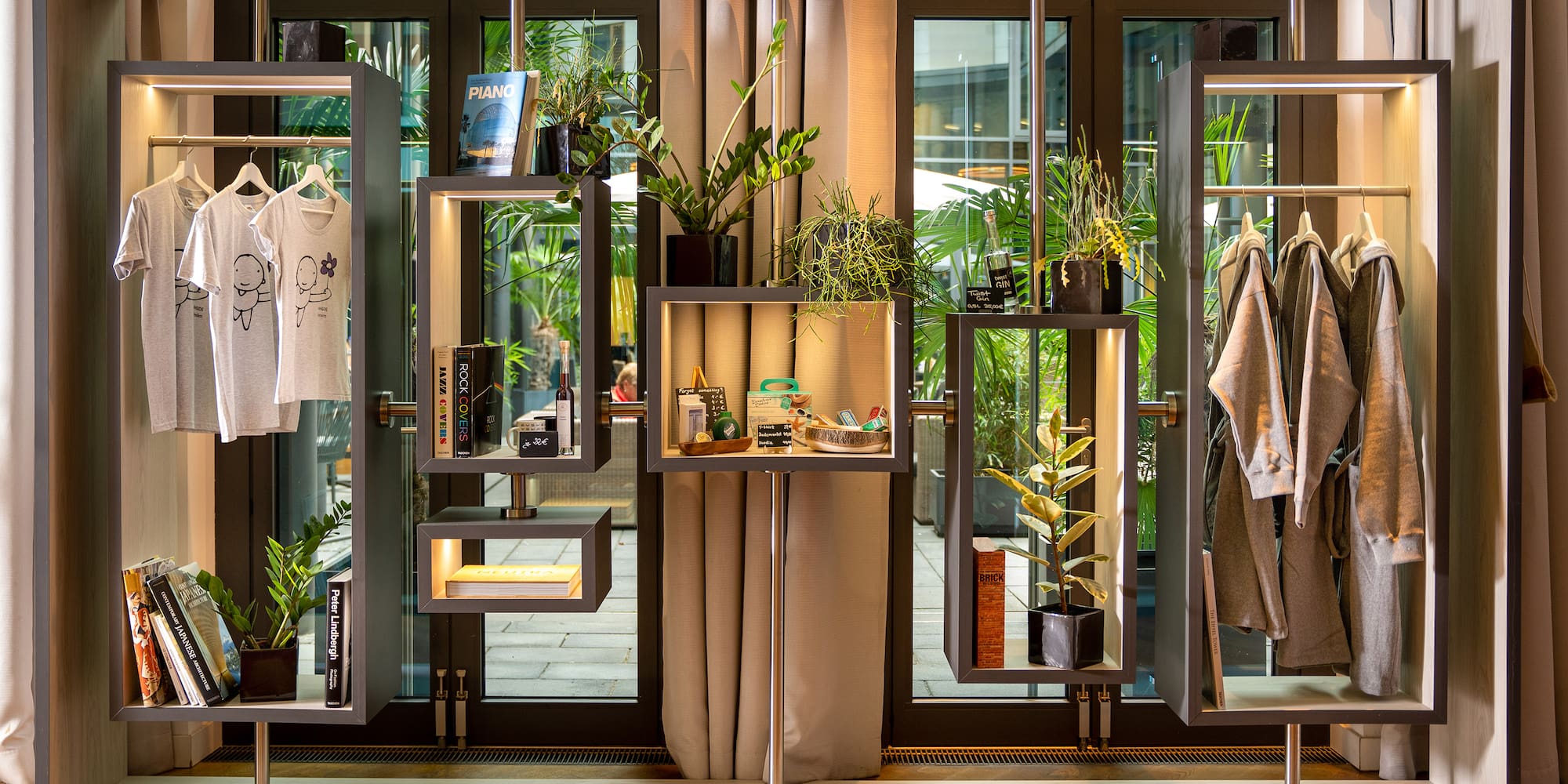 a display of clothing and plants