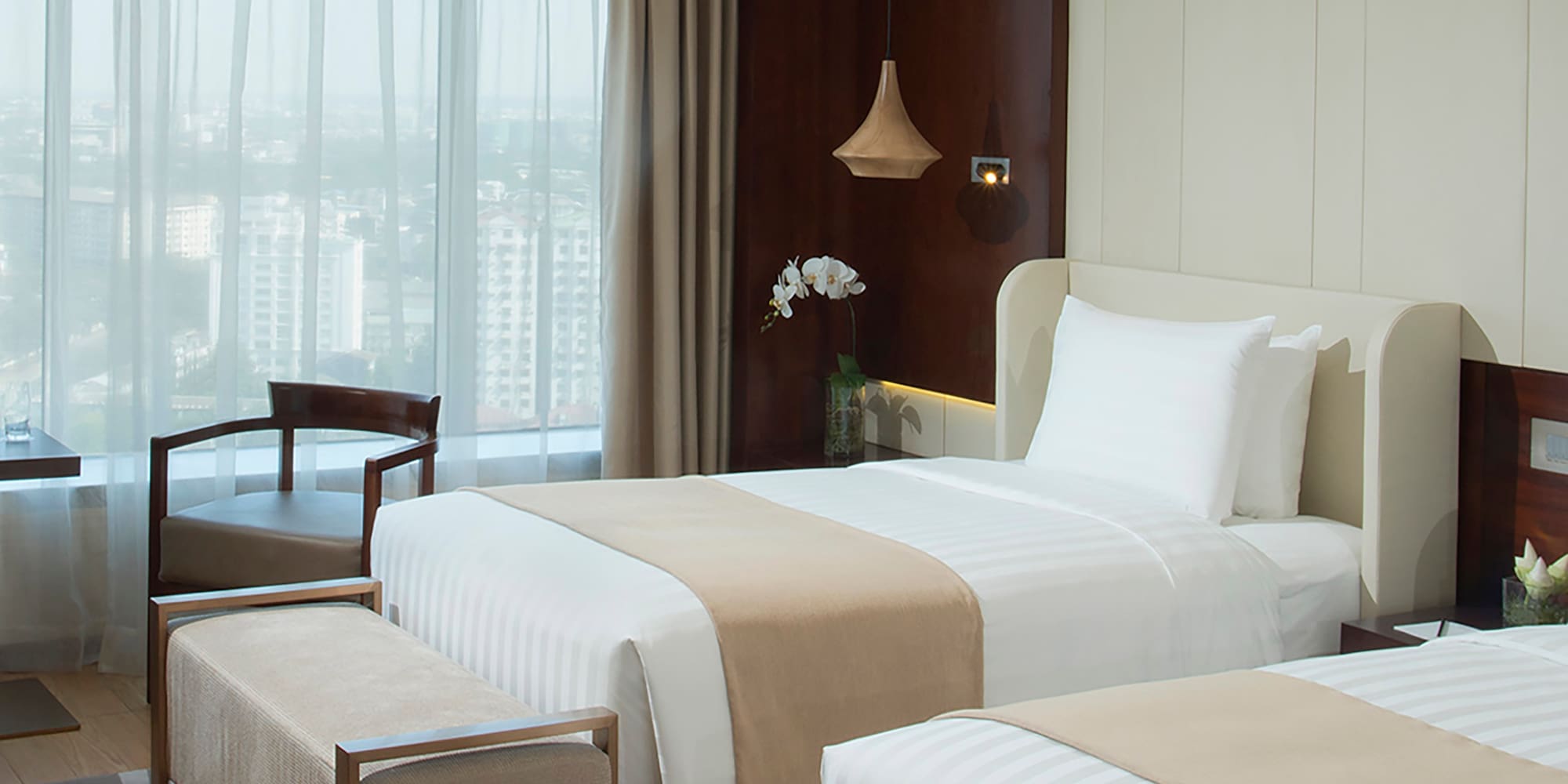 a room with two beds and a window