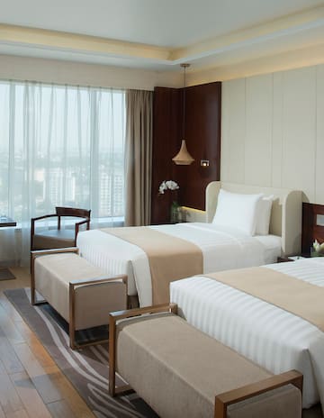 a room with two beds and a window