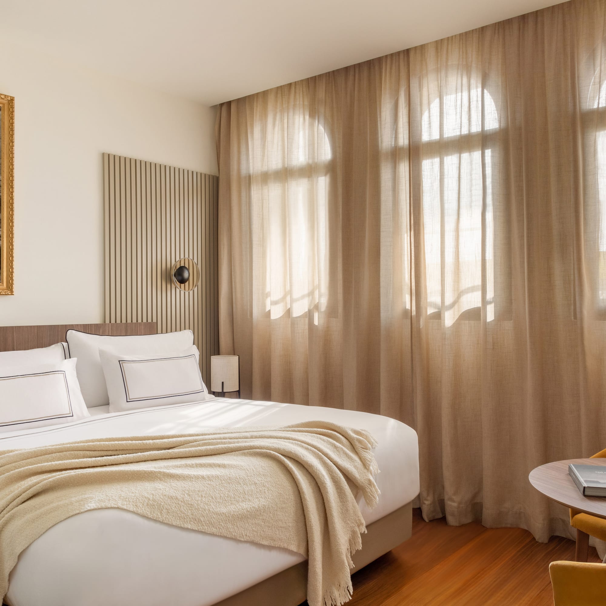 a bedroom with a bed and a table