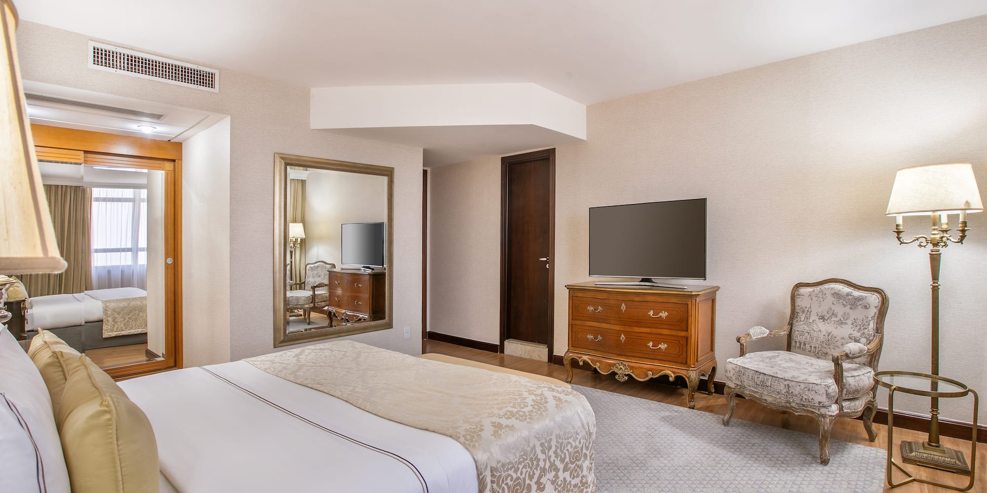 a bedroom with a television and a bed