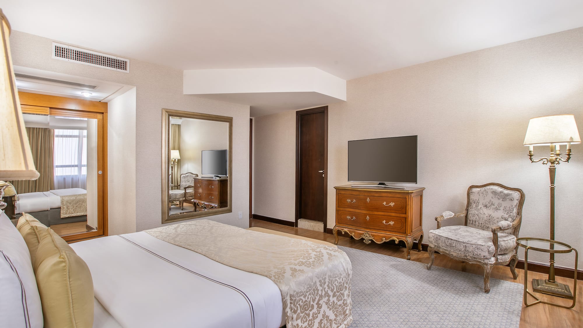 a bedroom with a television and a bed