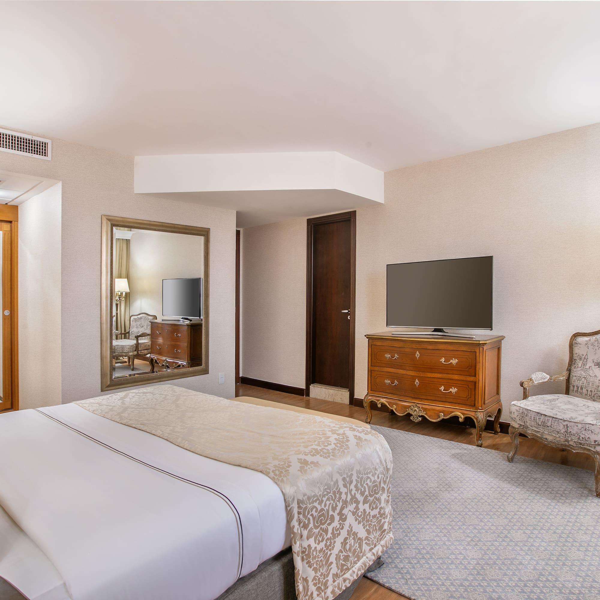 a bedroom with a television and a bed