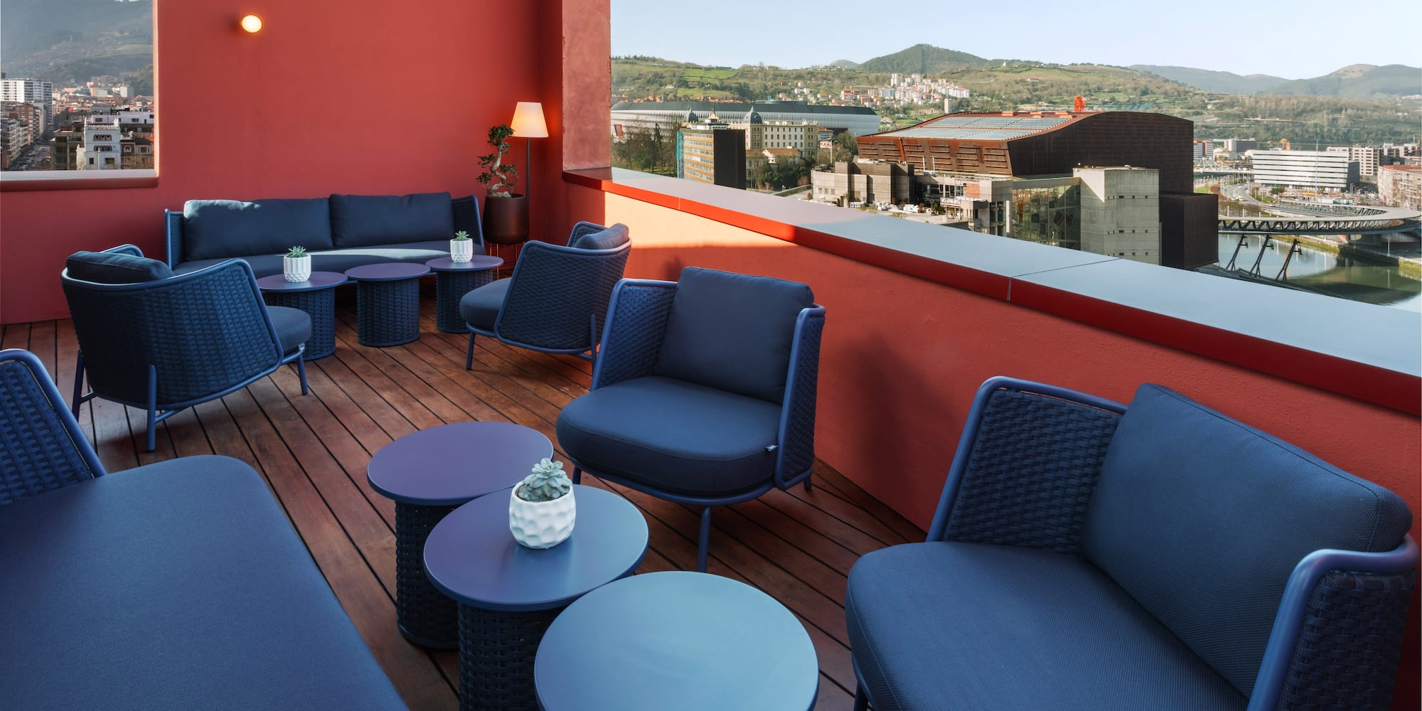 a patio with blue chairs and tables