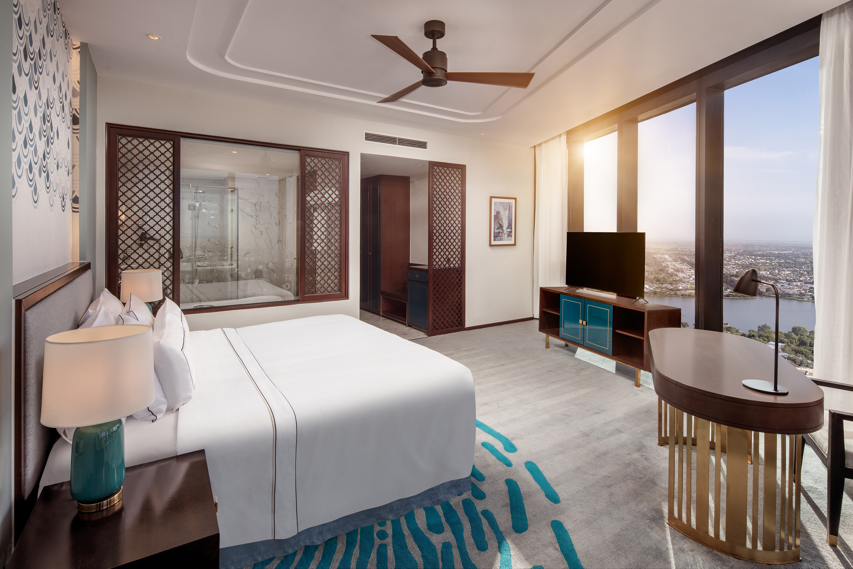 Modern hotel bedroom, large bed, city river view, contemporary design.