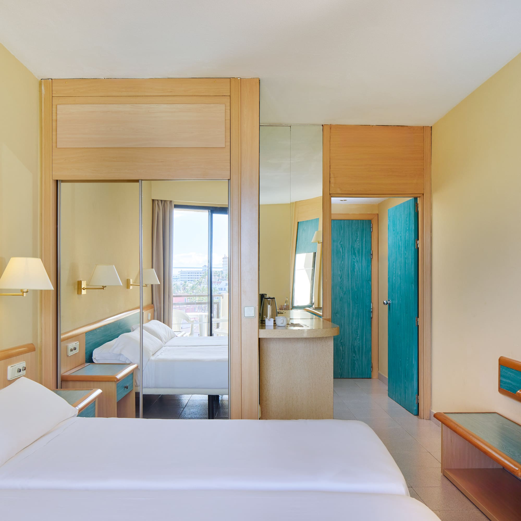 a room with a bed and a mirror