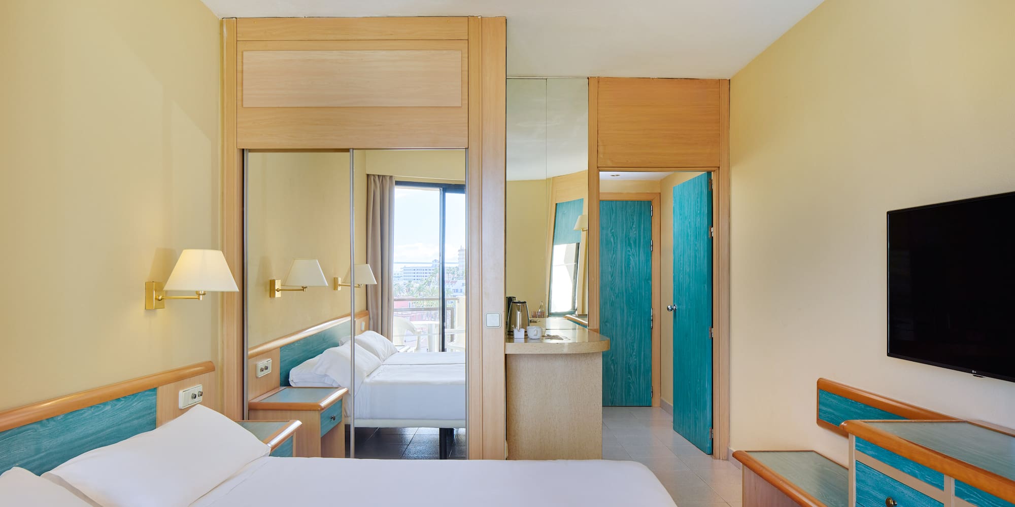 a room with a bed and a mirror