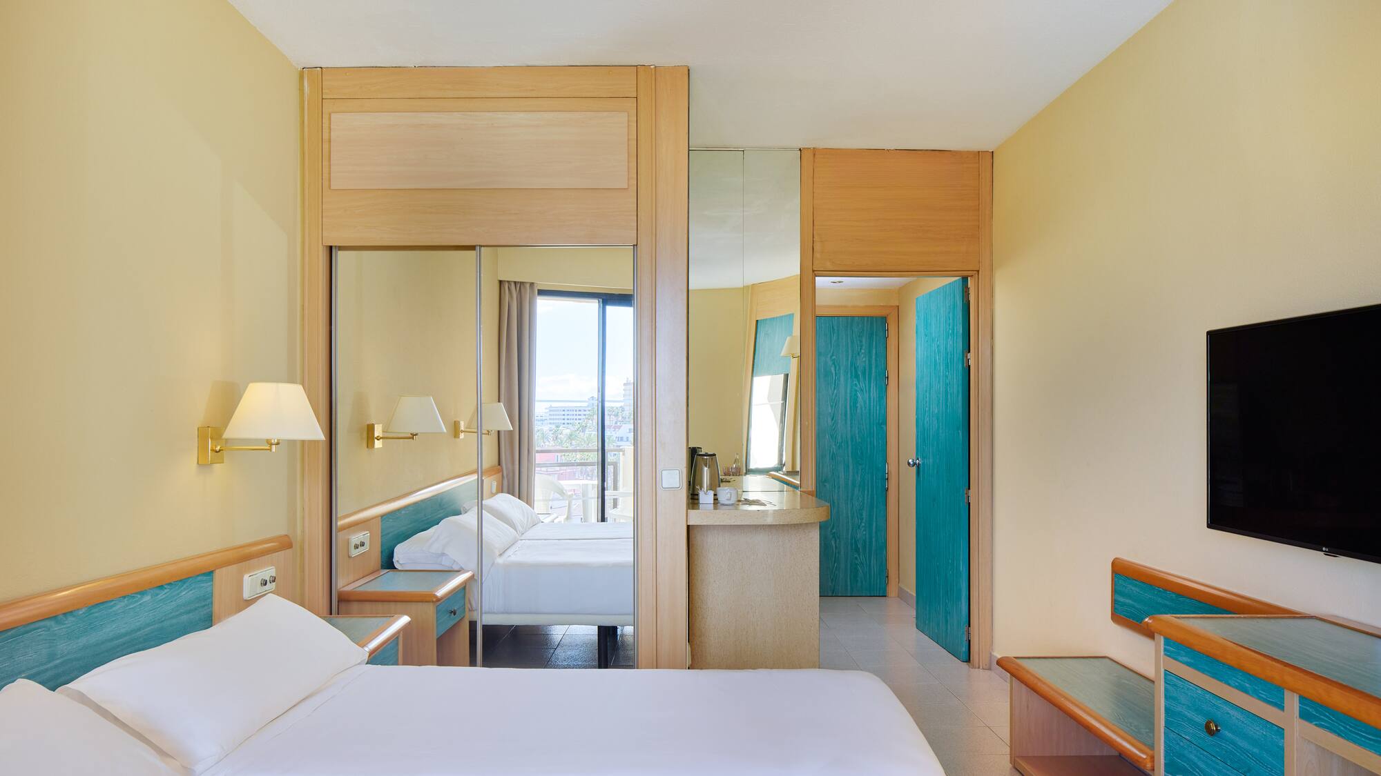 a room with a bed and a mirror