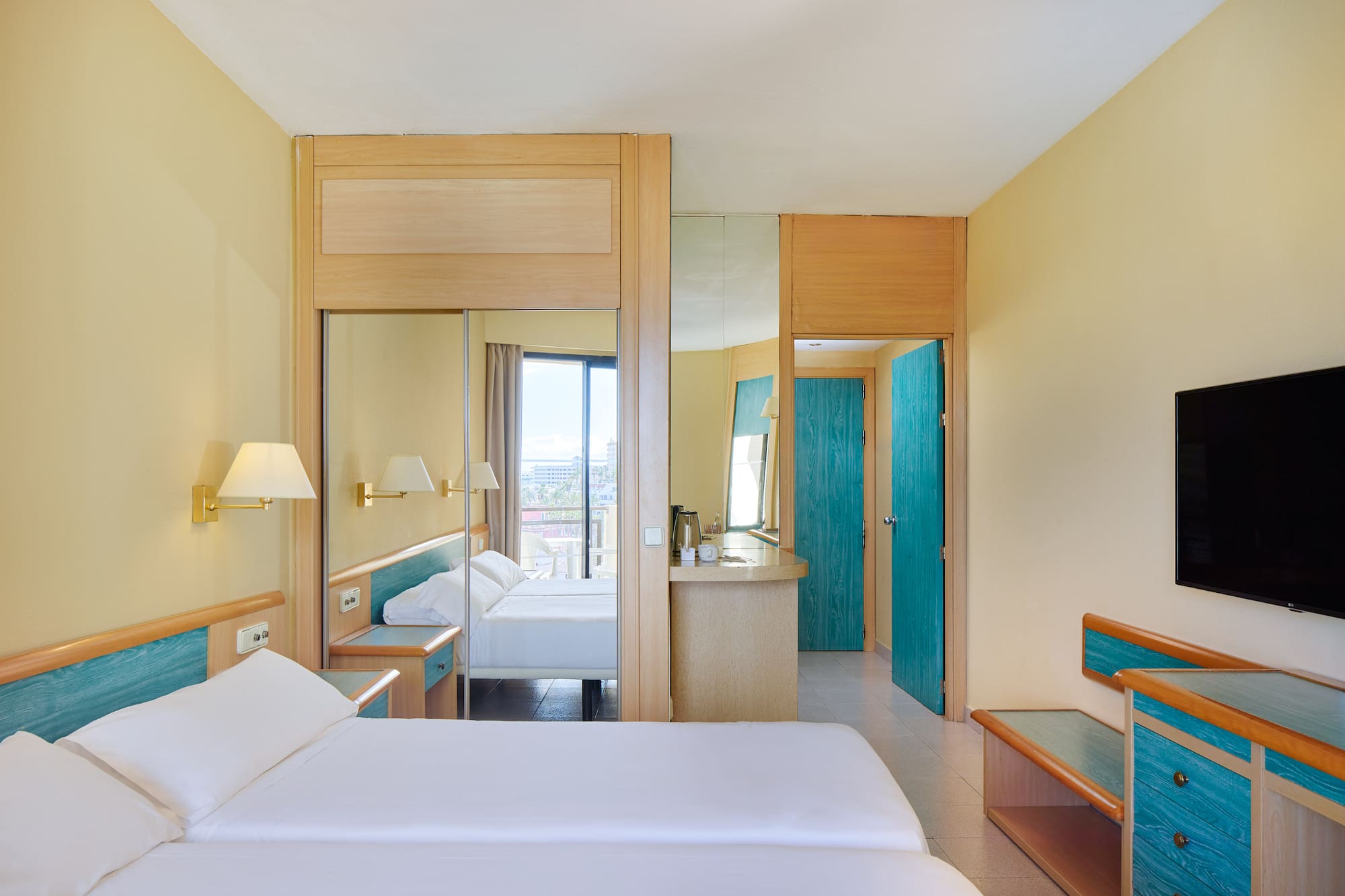 a room with a bed and a mirror