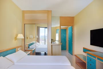 a room with a bed and a mirror