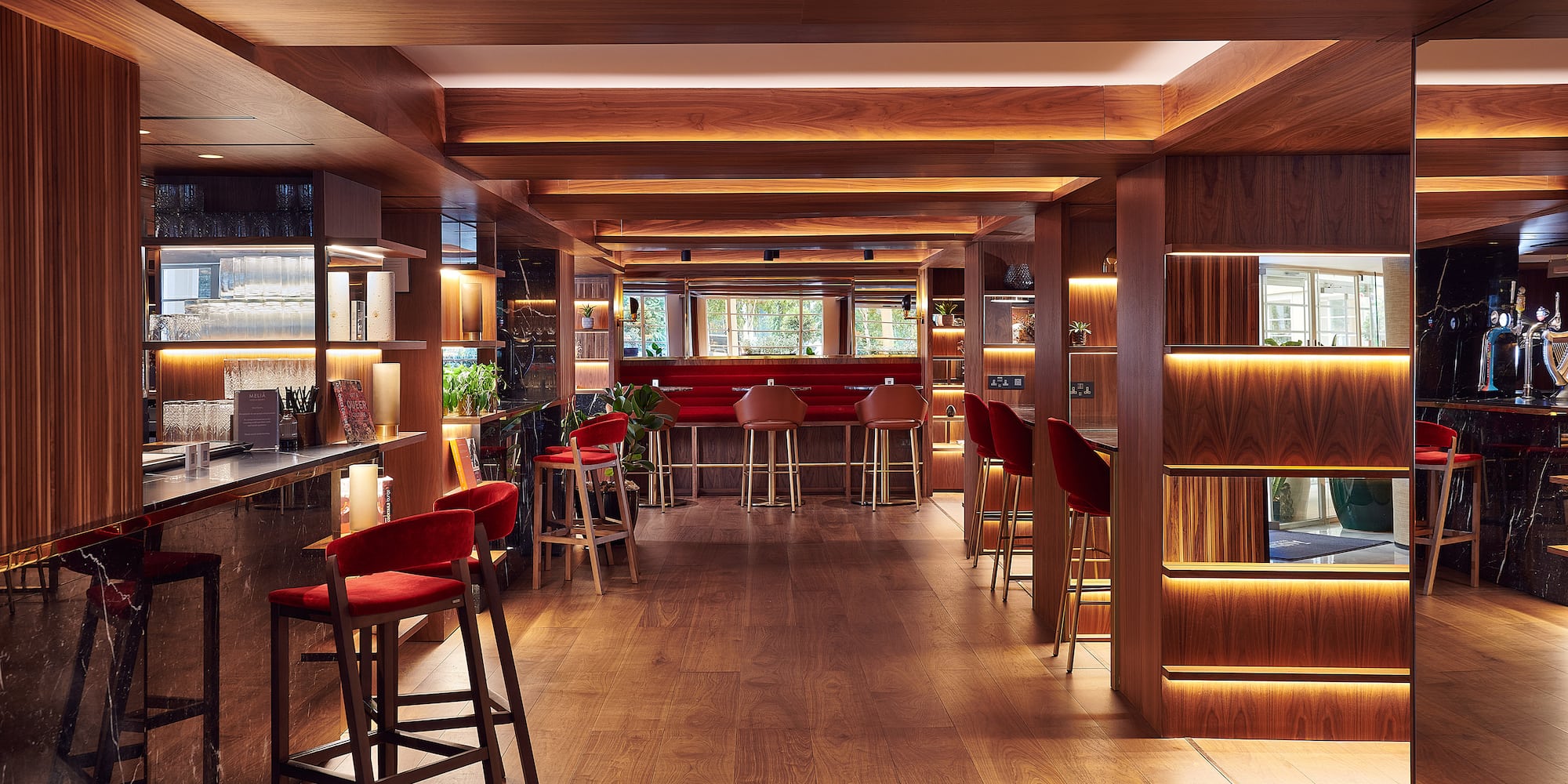 a room with a bar and chairs