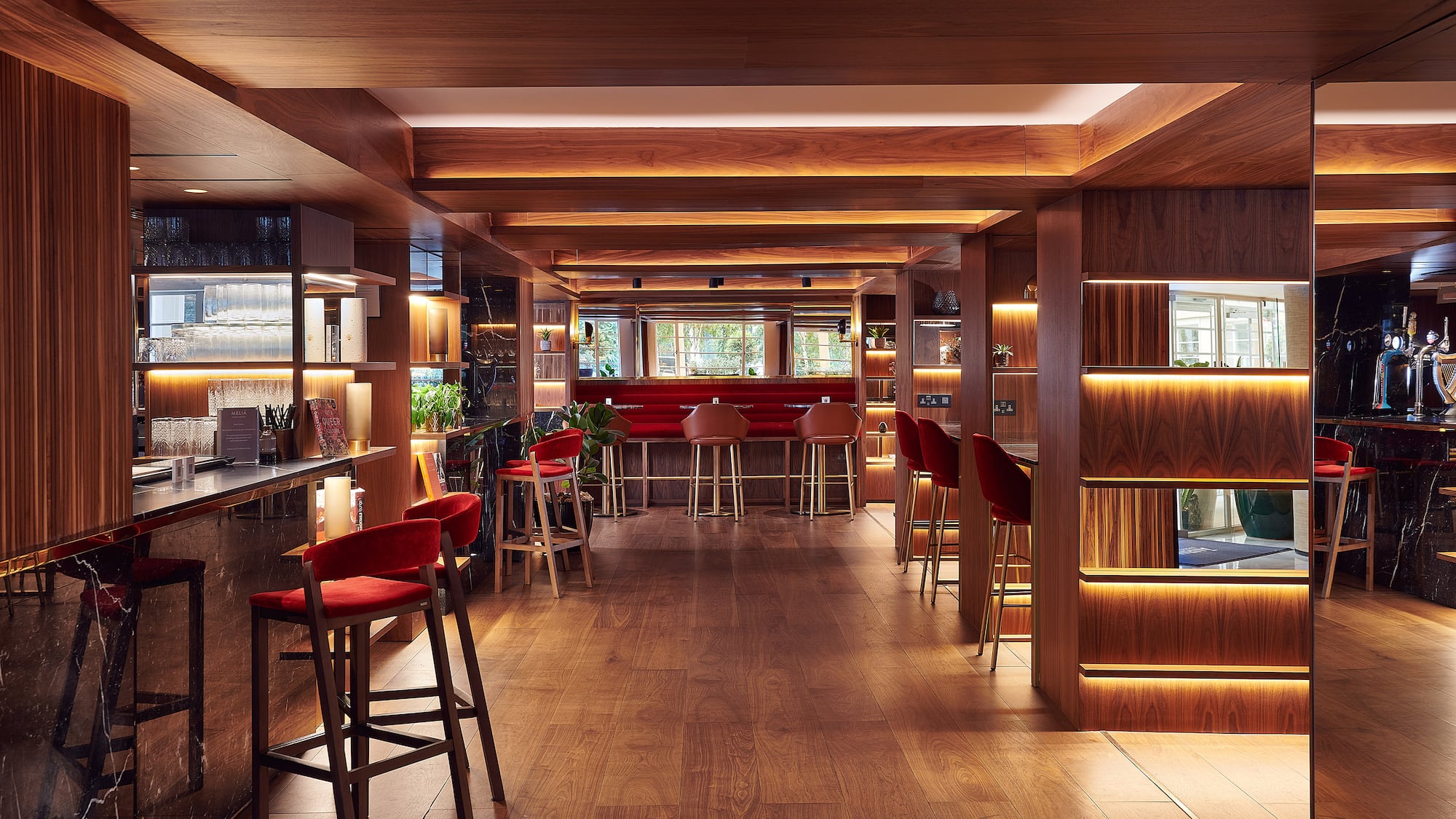 a room with a bar and chairs