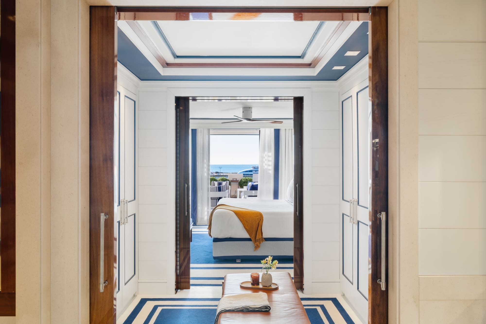 a room with a bed and a bench