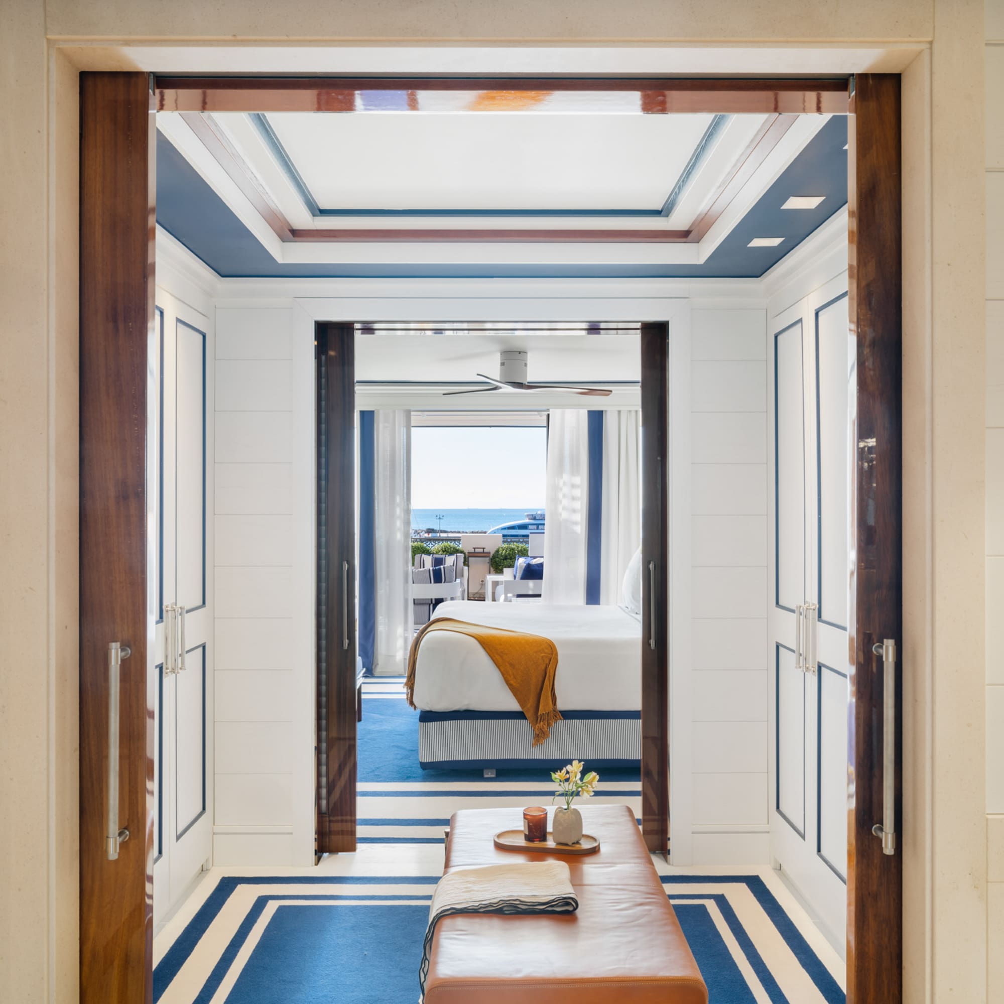 a room with a bed and a bench