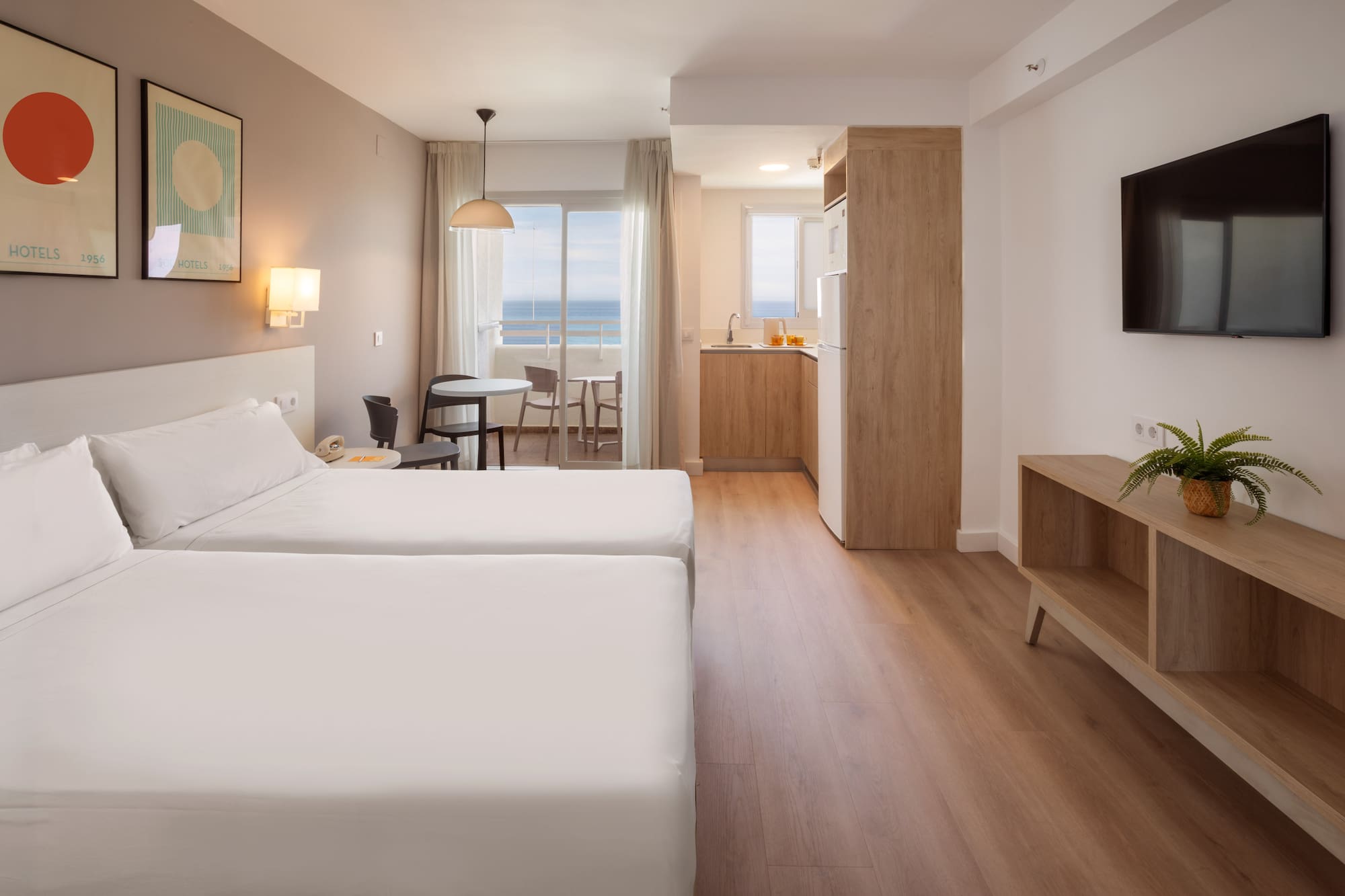 Hotel studio apartment with twin beds, kitchenette, balcony, sea view.