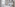Bright hotel bedroom with white double bed, sheer curtains, and modern art.