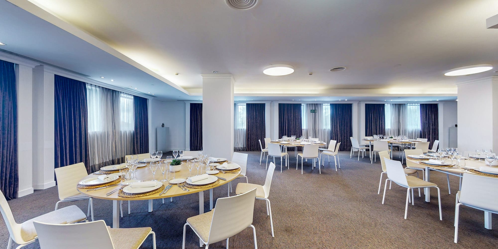 a room with a round table and chairs