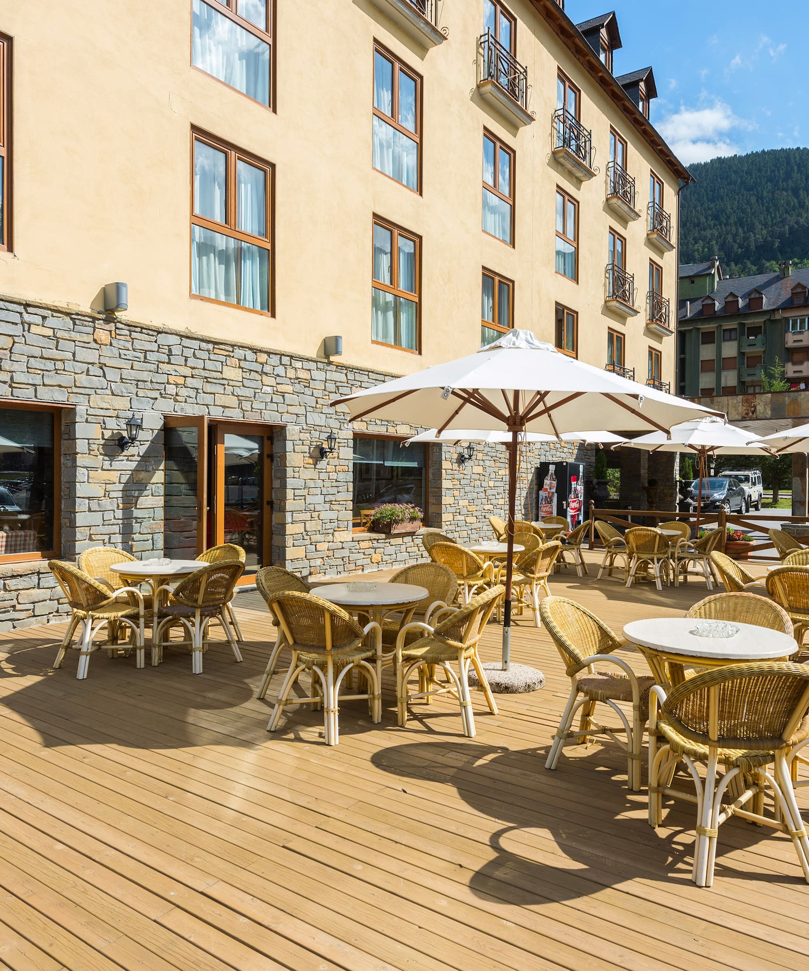 a patio area with tables and umbrellas
