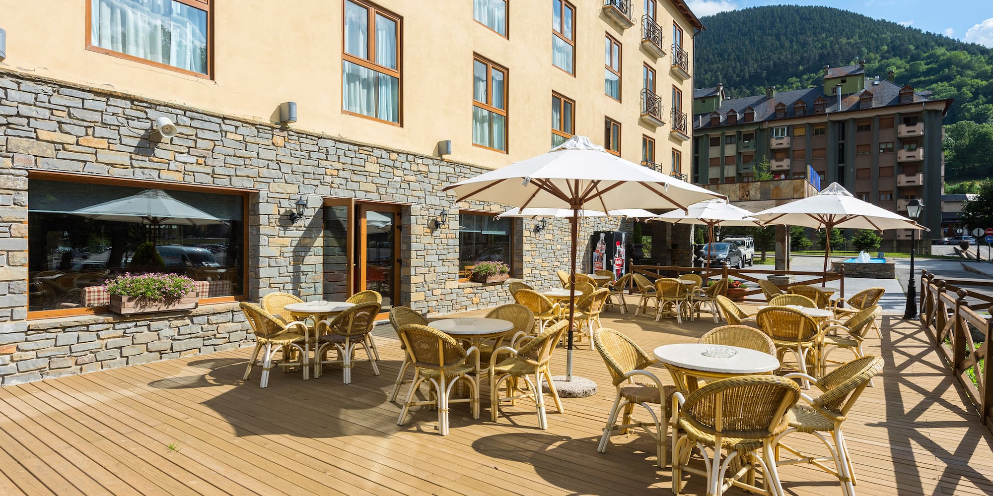 a patio area with tables and umbrellas