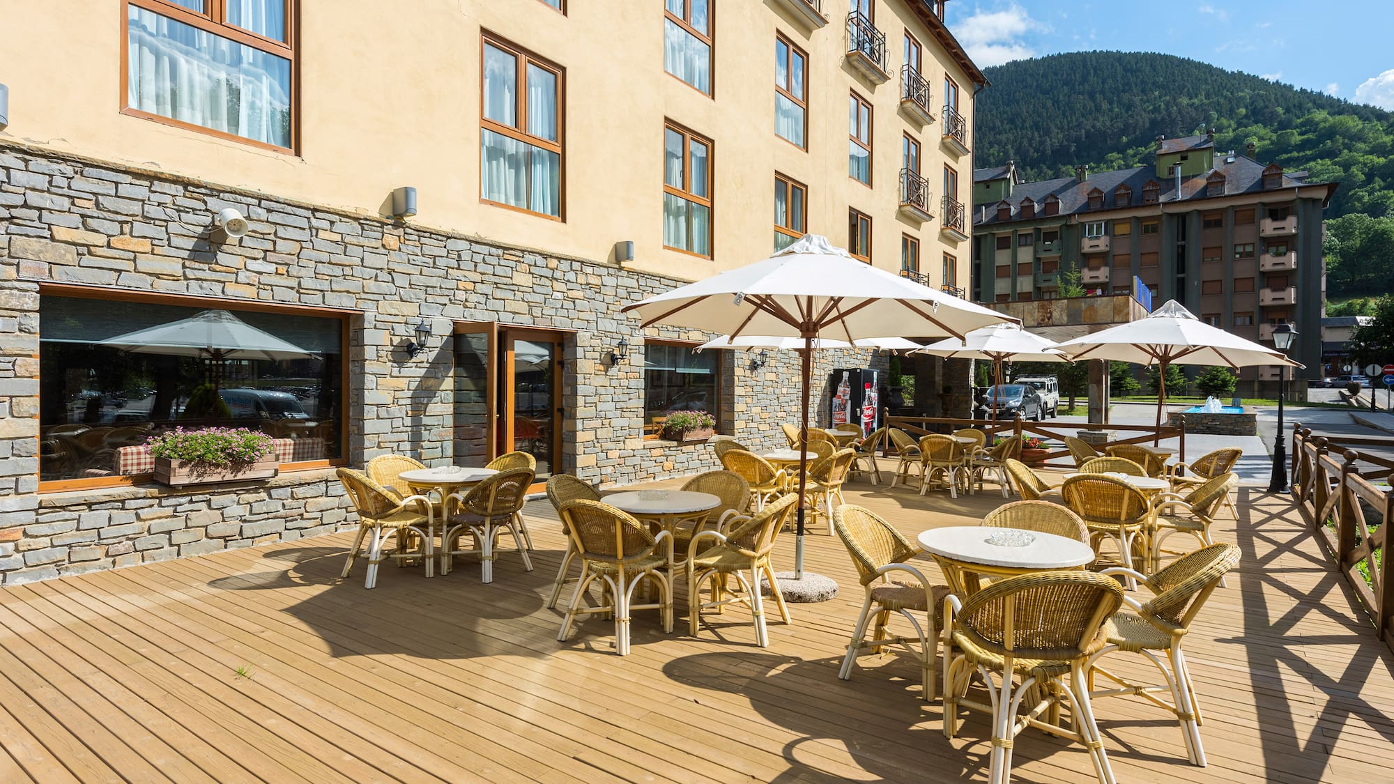 a patio area with tables and umbrellas