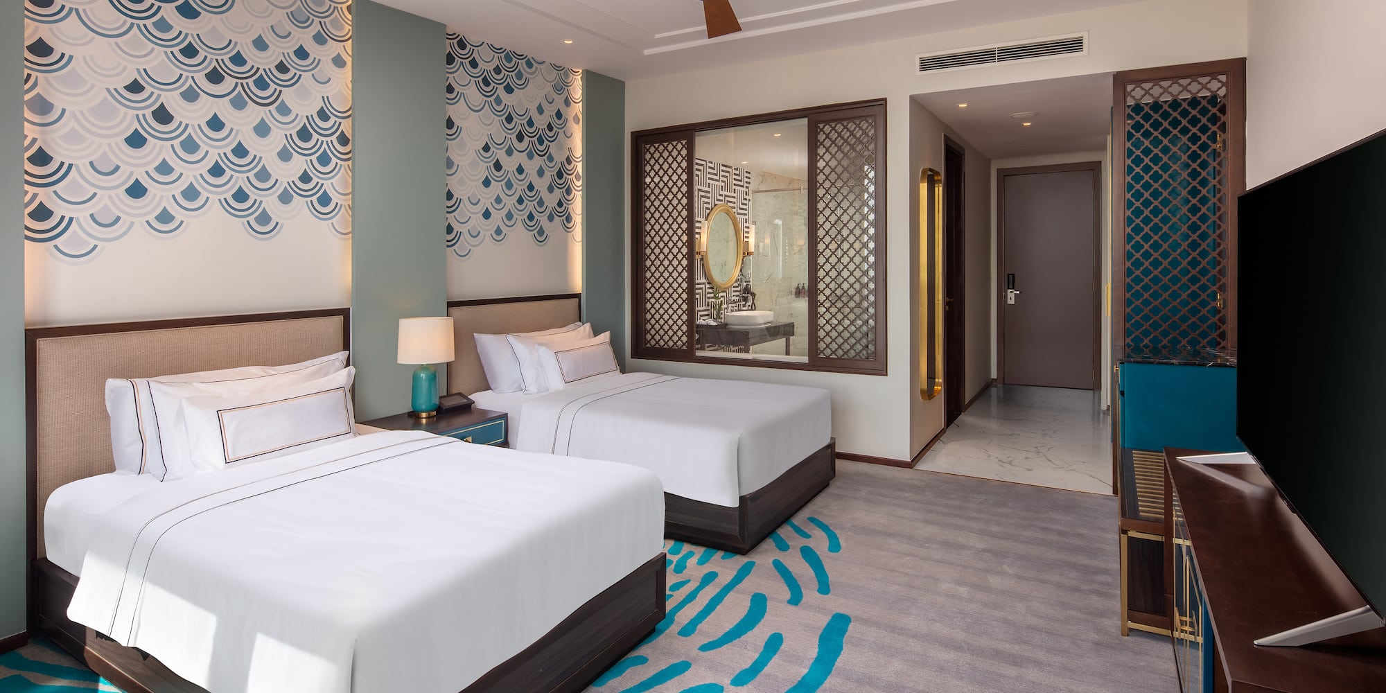 a room with two beds and a fan