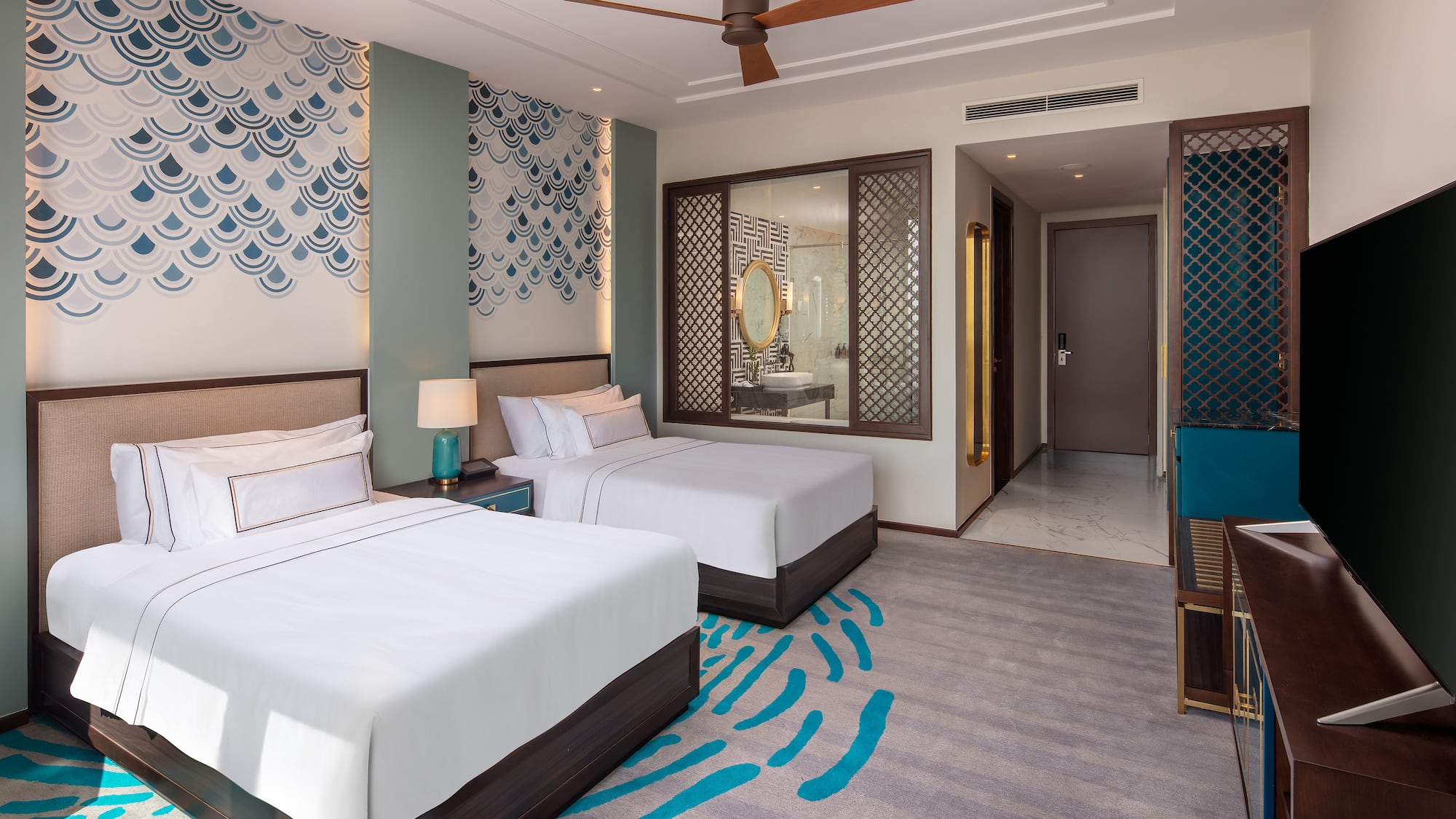 a room with two beds and a fan