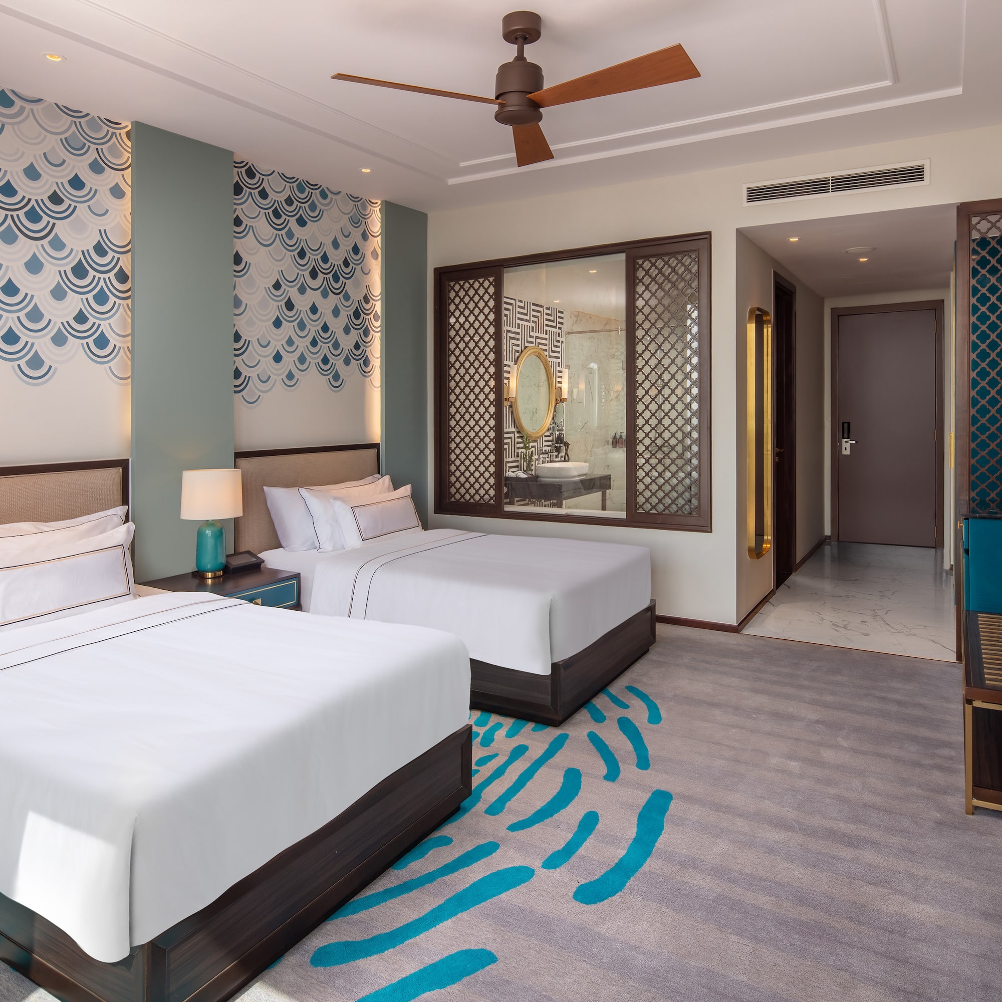 a room with two beds and a fan