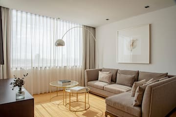 a living room with a couch and a lamp