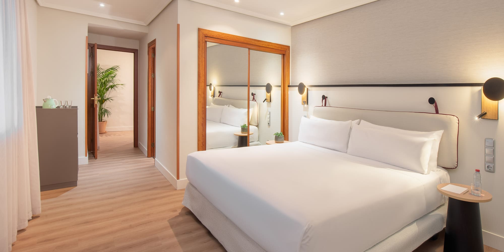 a bedroom with a mirror and a bed