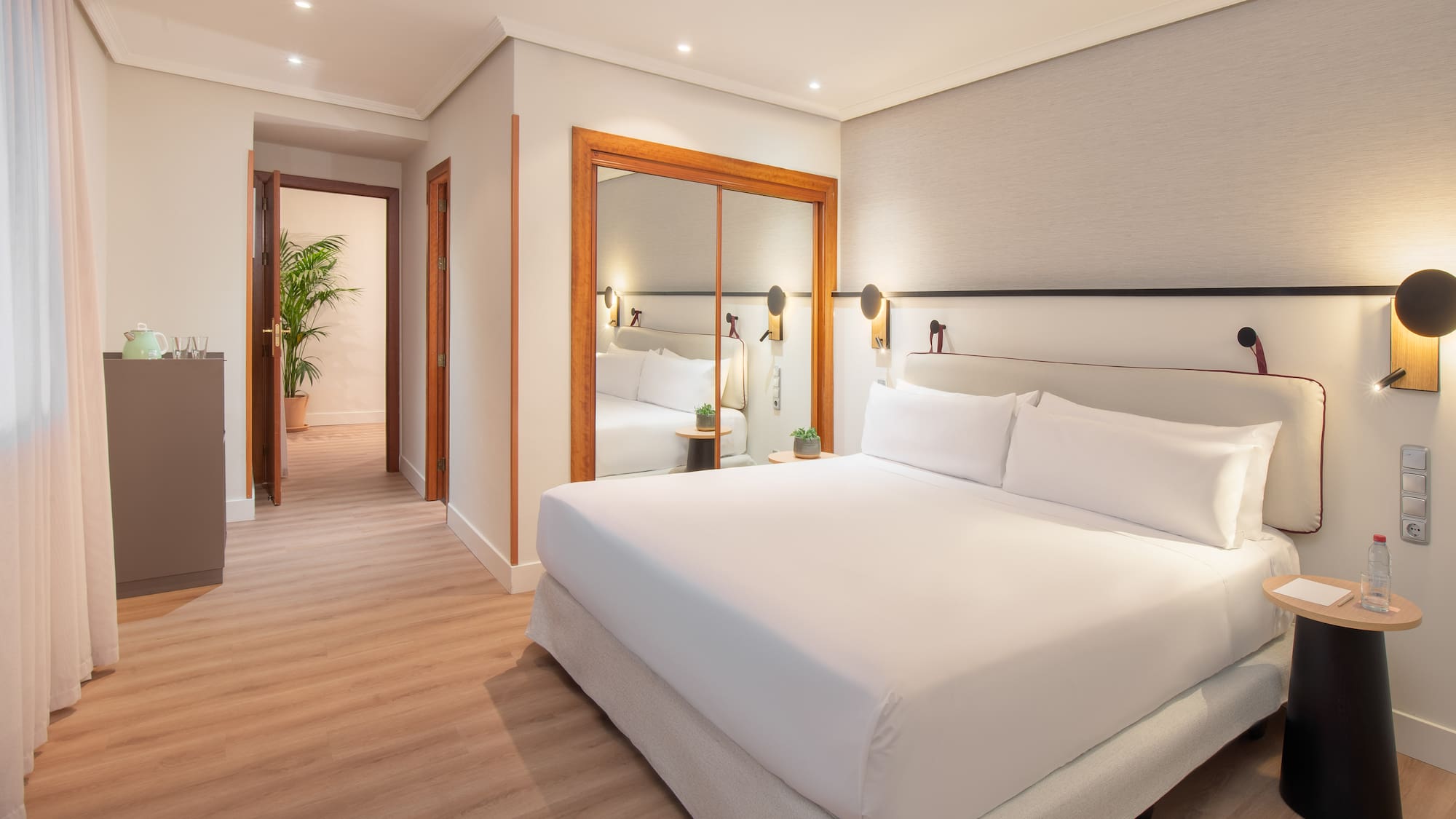 a bedroom with a mirror and a bed