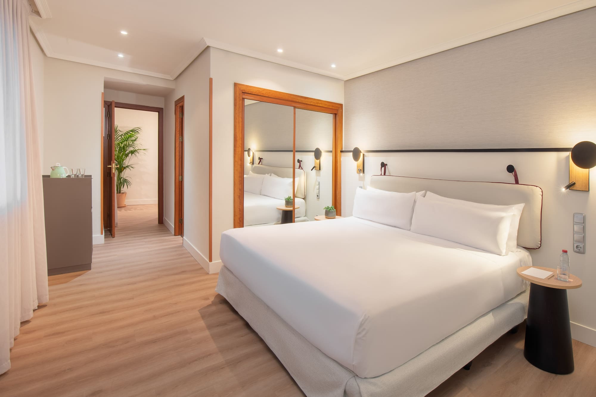 a bedroom with a mirror and a bed