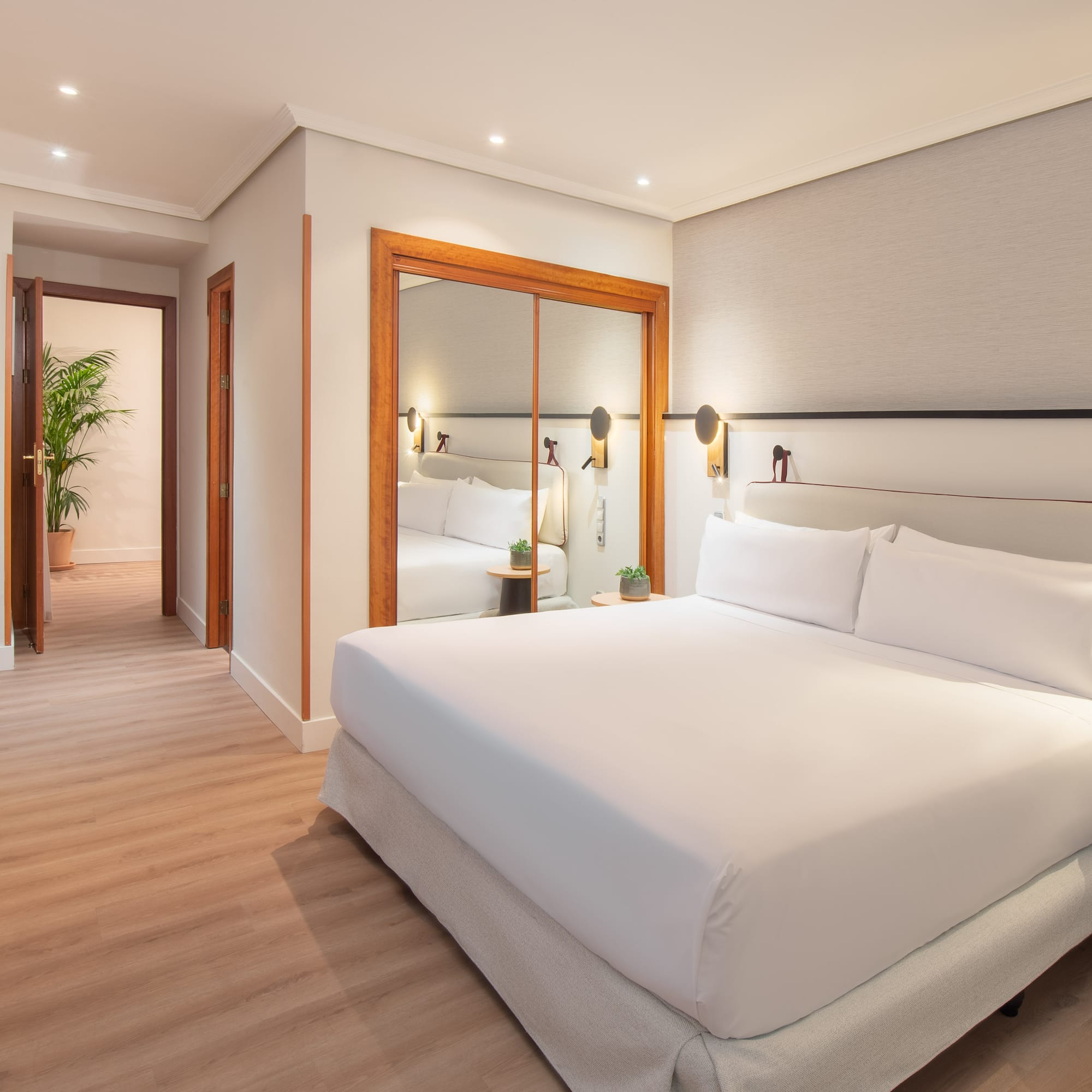 a bedroom with a mirror and a bed