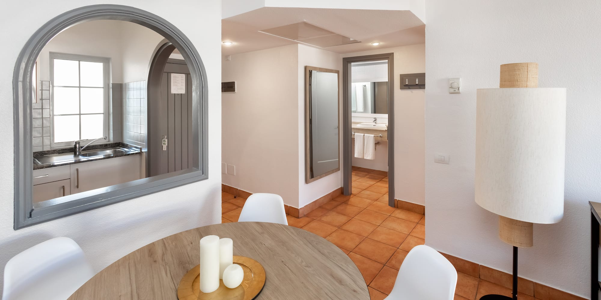 a room with a round table and chairs