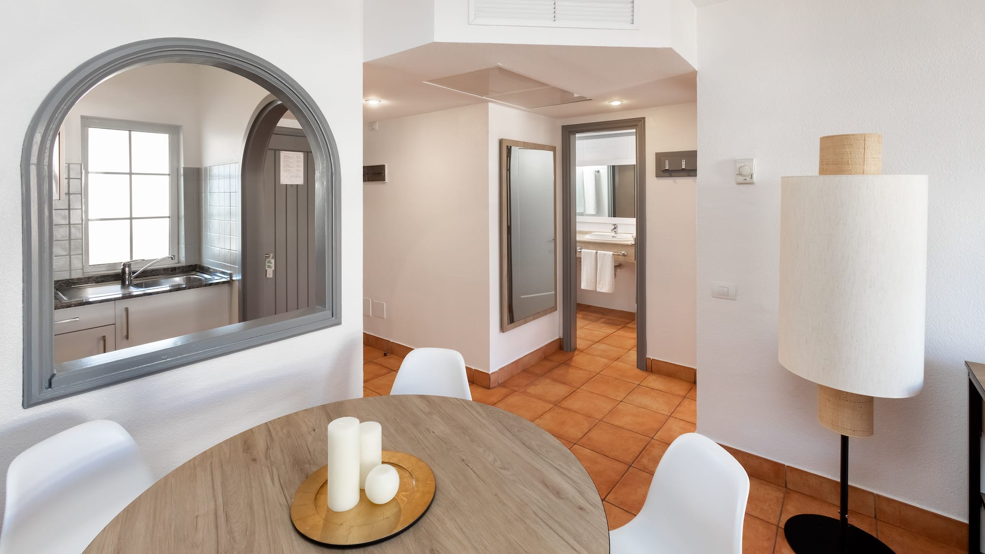 a room with a round table and chairs