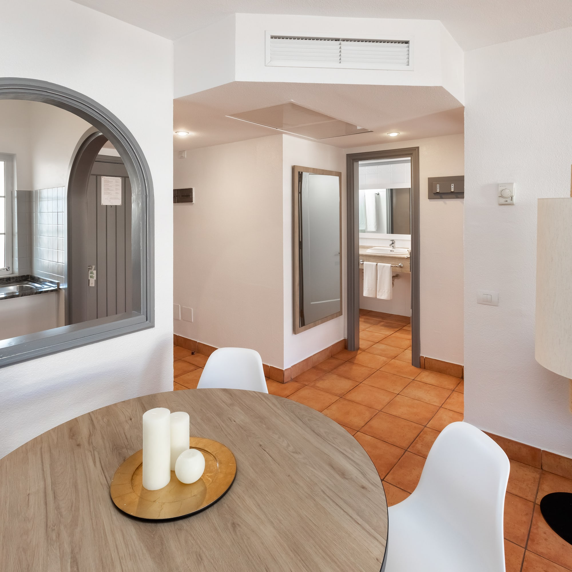 a room with a round table and chairs