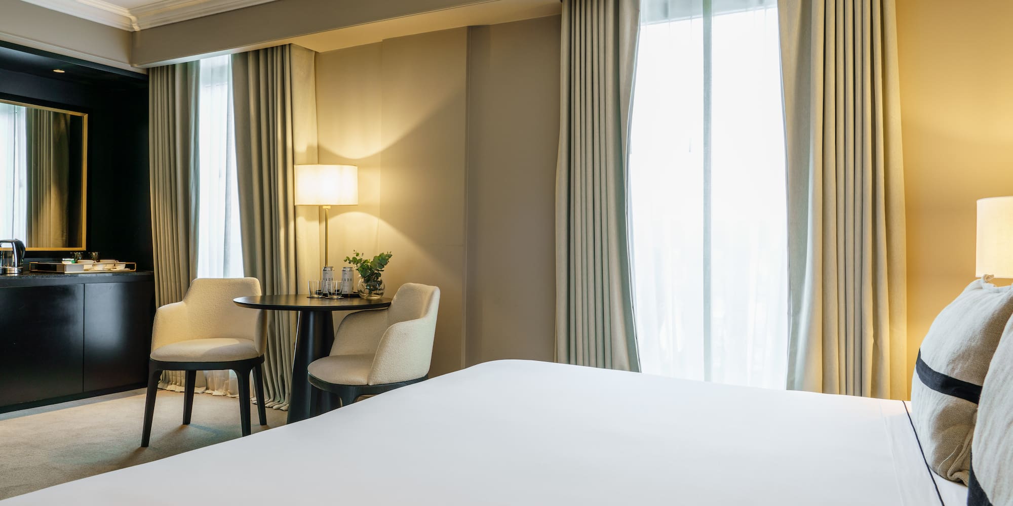 a room with a bed and chairs